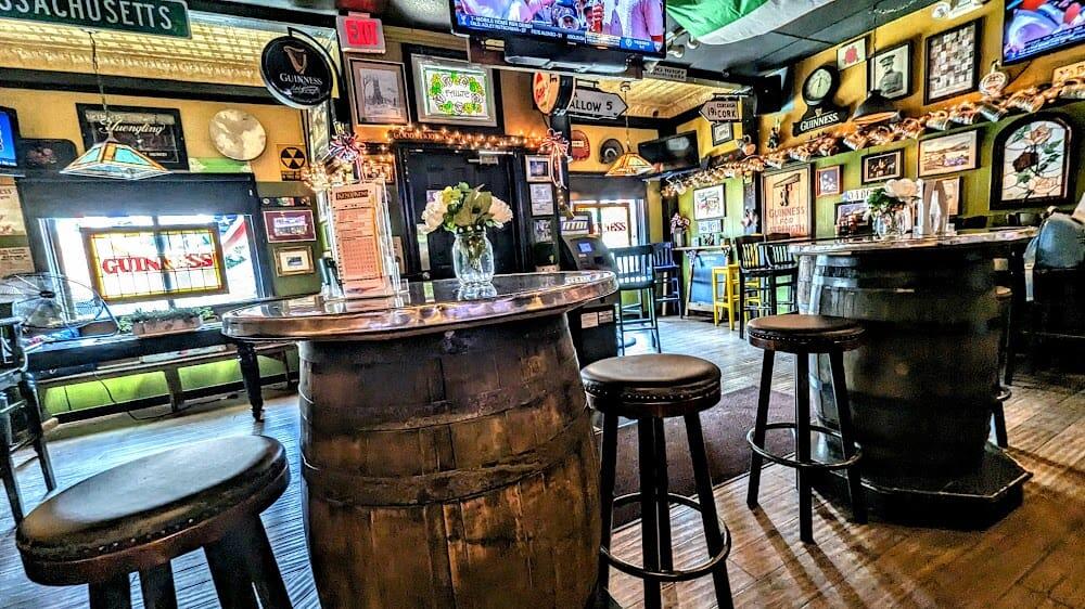 Whiskey-barrel tables and walls of framed photos in the back room