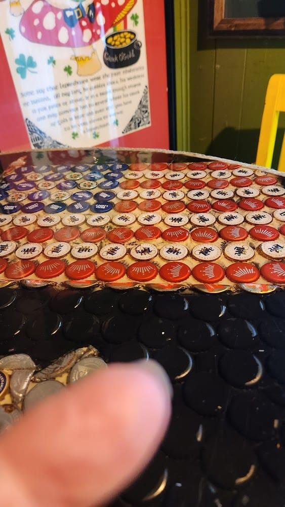 The signature Red Rose bottle-cap-and-resin table top